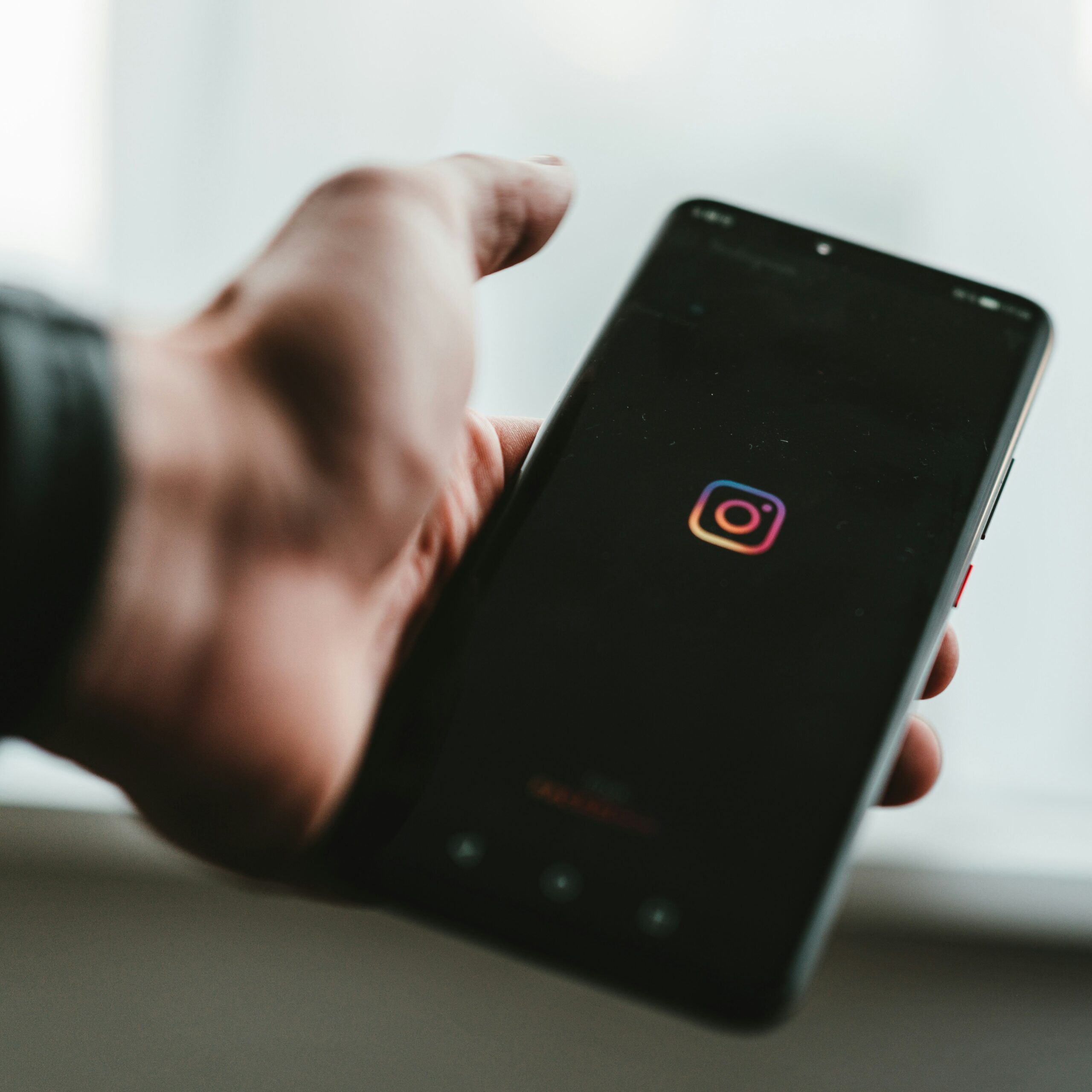 Close up of person opening Instagram app